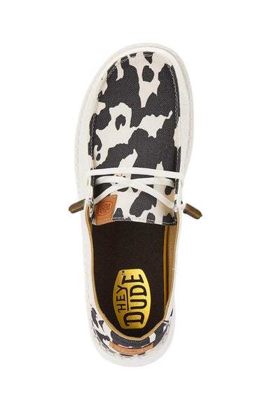 HEYDUDE Women’s Wendy Cow Print Shoes in White/Black